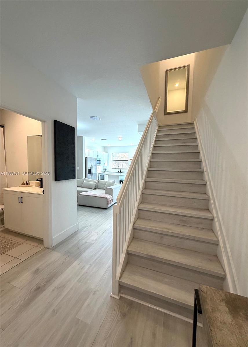 14724 Southwest 181st Terrace Miami, FL 33187 - Photo 26 of 36 a view of a livingroom with wooden floor and stairs