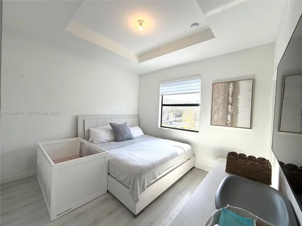 a bedroom with a bed and a couch