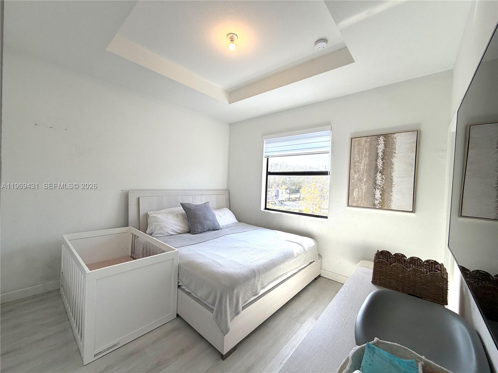 14724 Southwest 181st Terrace Miami, FL 33187 - Photo 28 of 36 a bedroom with a bed and a couch