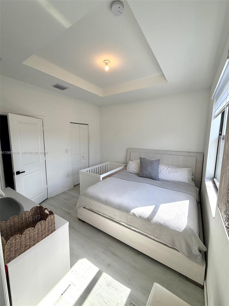 14724 Southwest 181st Terrace Miami, FL 33187 - Photo 30 of 36 a bedroom with a bed and a couch