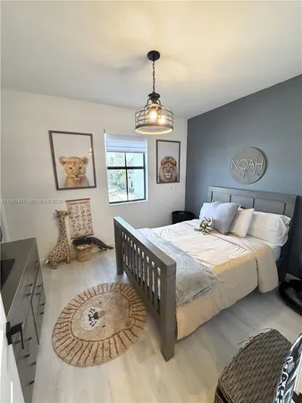 a bed sitting in a bedroom next to a window