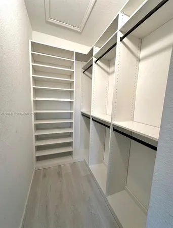 a view of walk in closet with empty racks