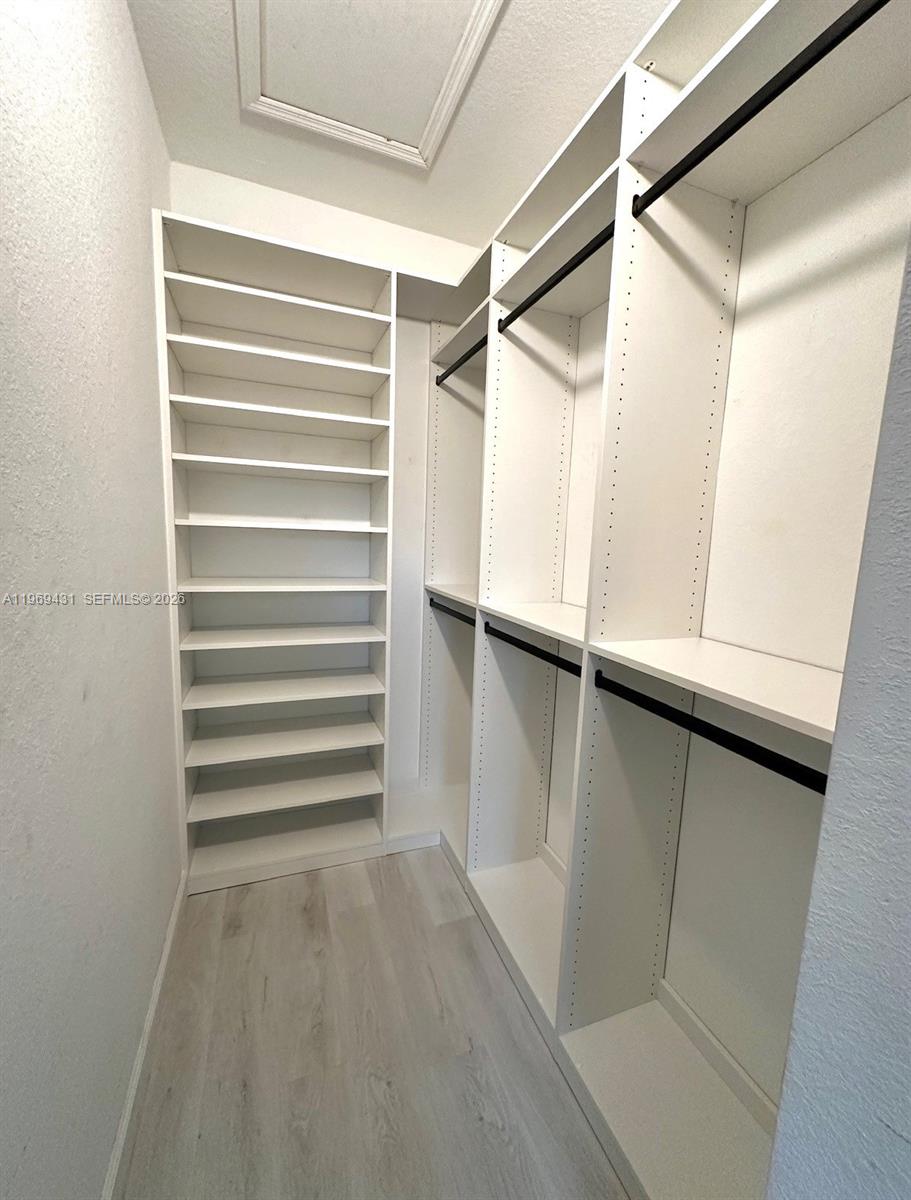 14724 Southwest 181st Terrace Miami, FL 33187 - Photo 32 of 36 a view of walk in closet with empty racks