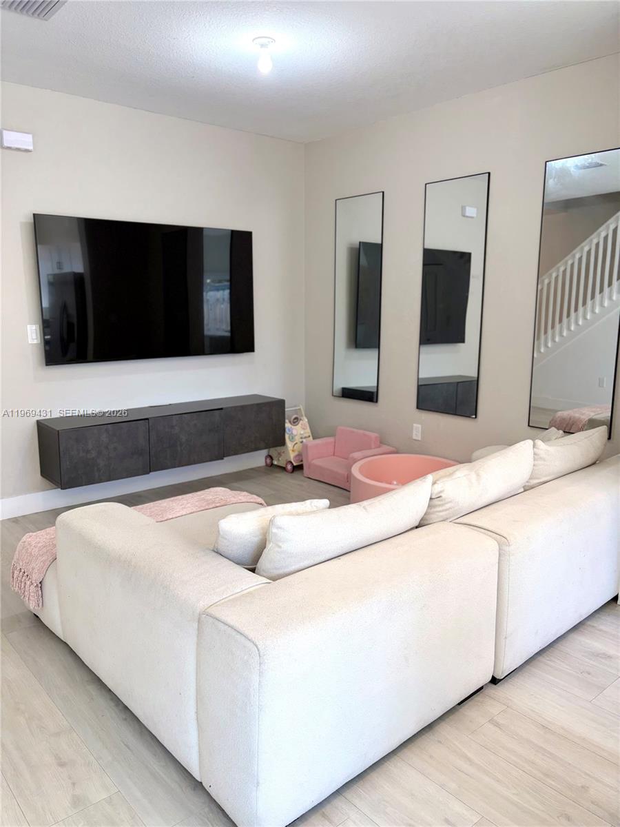 14724 Southwest 181st Terrace Miami, FL 33187 - Photo 7 of 36 a bedroom with a bed and a flat screen tv