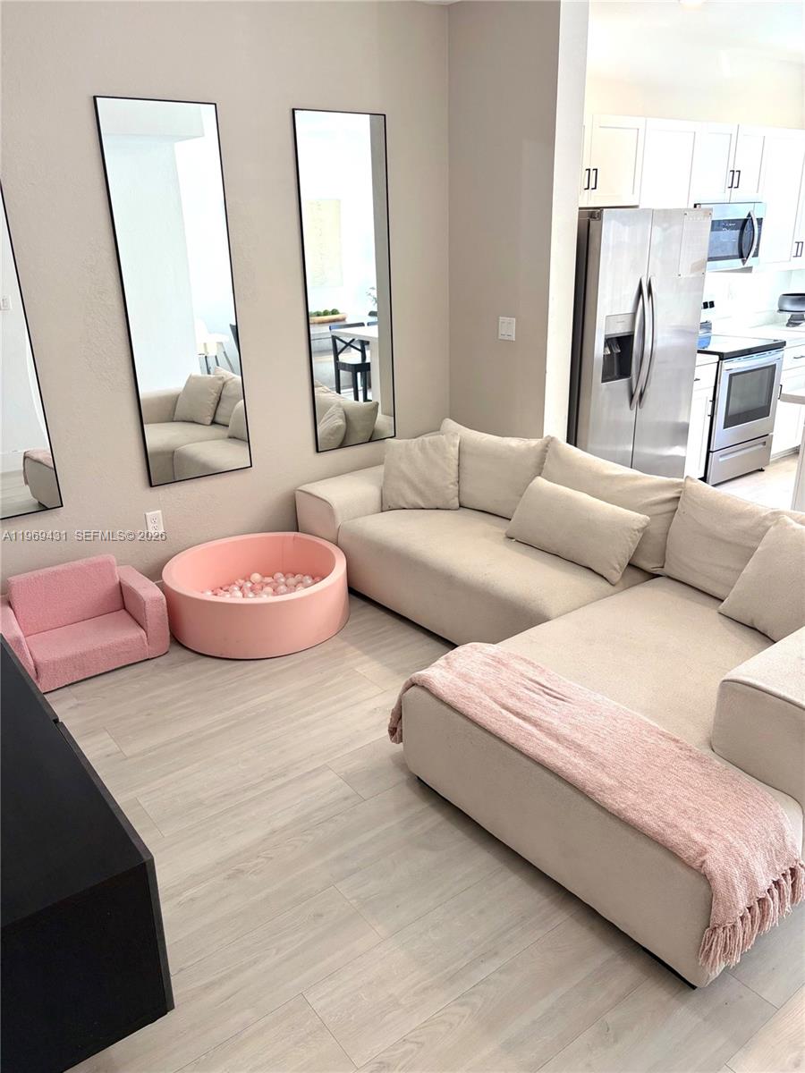 14724 Southwest 181st Terrace Miami, FL 33187 - Photo 9 of 36 a bedroom with a bed and a couch