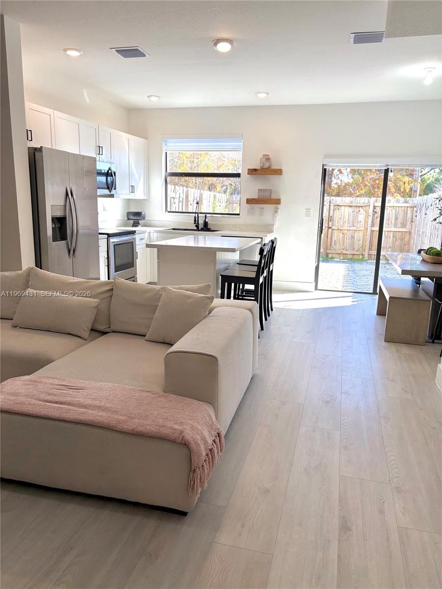 14724 Southwest 181st Terrace Miami, FL 33187 - Photo 10 of 36 a living room with furniture and a large window
