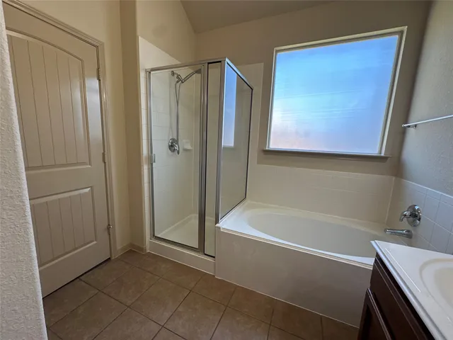 a bathroom with a tub and shower
