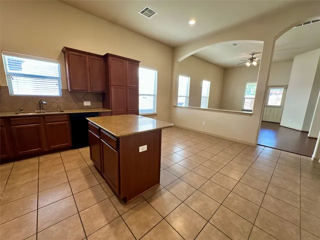 a kitchen with stainless steel appliances granite countertop a sink and cabinets