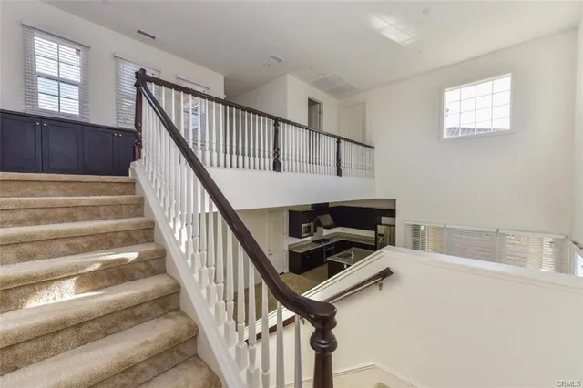 a view of staircase with white walls and windows