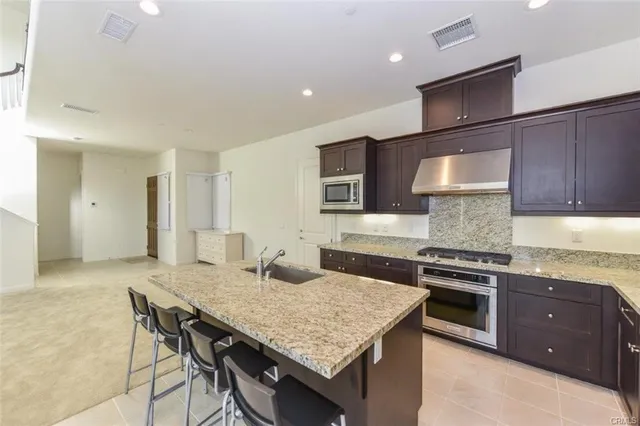 a kitchen with a stove and a kitchen island