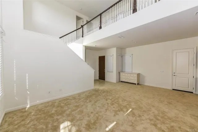 a view of an empty room with stairs