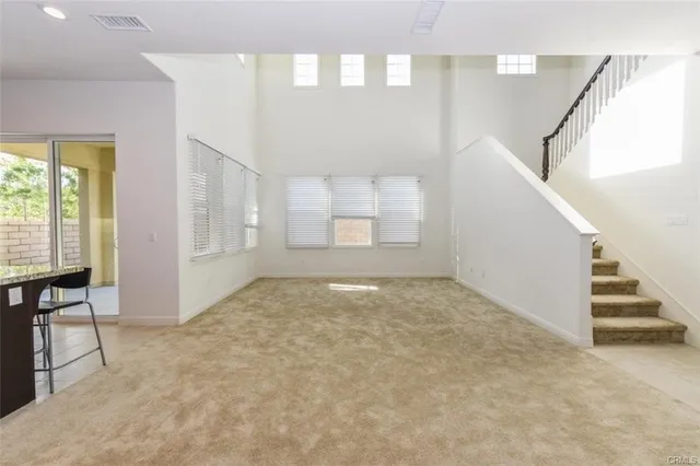 a view of an empty room with stairs