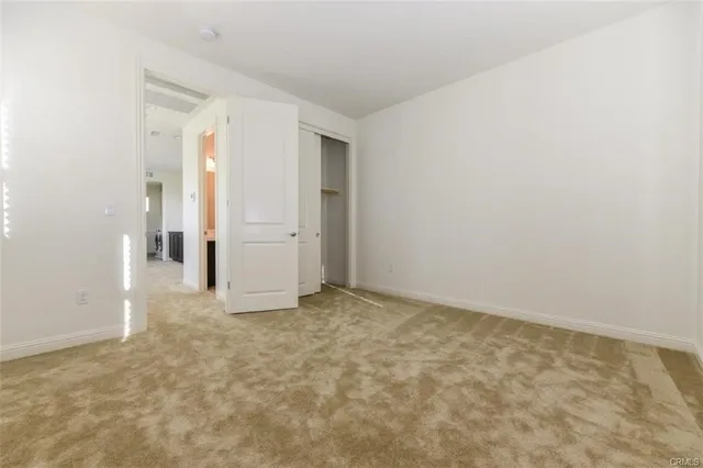 an empty room with an entrance to other room