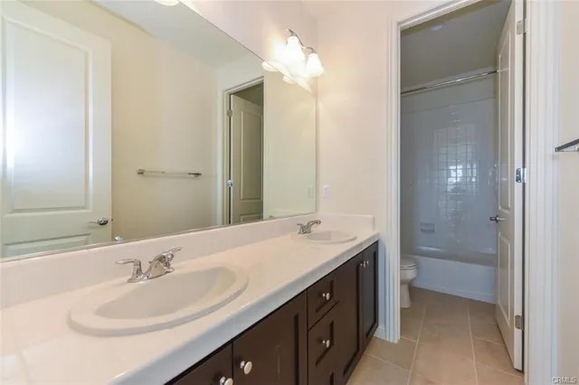 a bathroom with a sink double vanity and a mirror