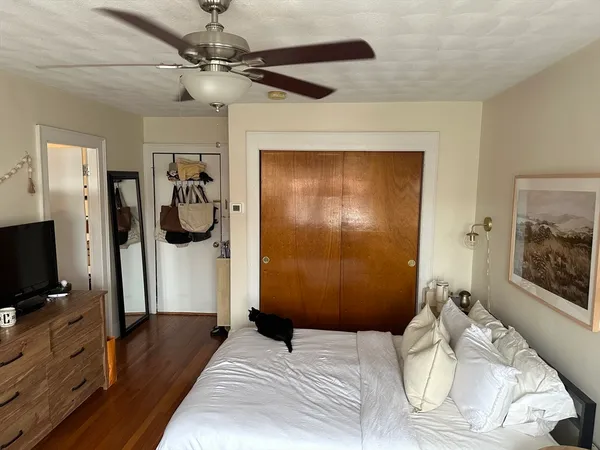 a bedroom with a bed and a mirror on the dresser