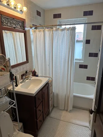 a bathroom with a sink a mirror and a bathtub