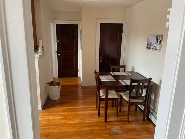 a view of a dining room with furniture and wooden floor