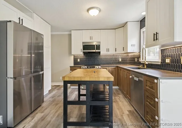 a kitchen with a refrigerator and a sink