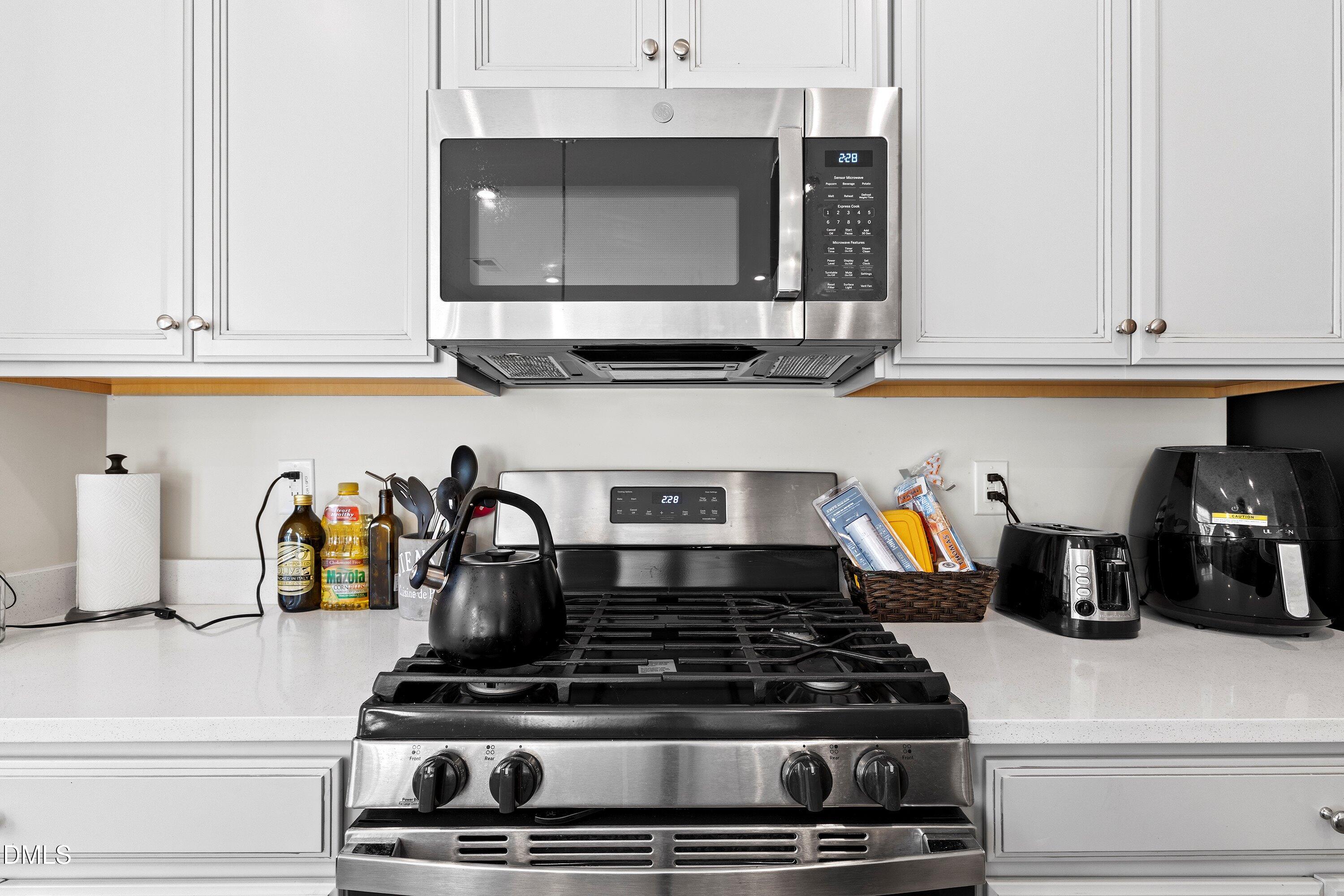 6430 Pathfinder Way Raleigh, NC 27616 - Photo 11 of 39 a kitchen with a stove and cabinets