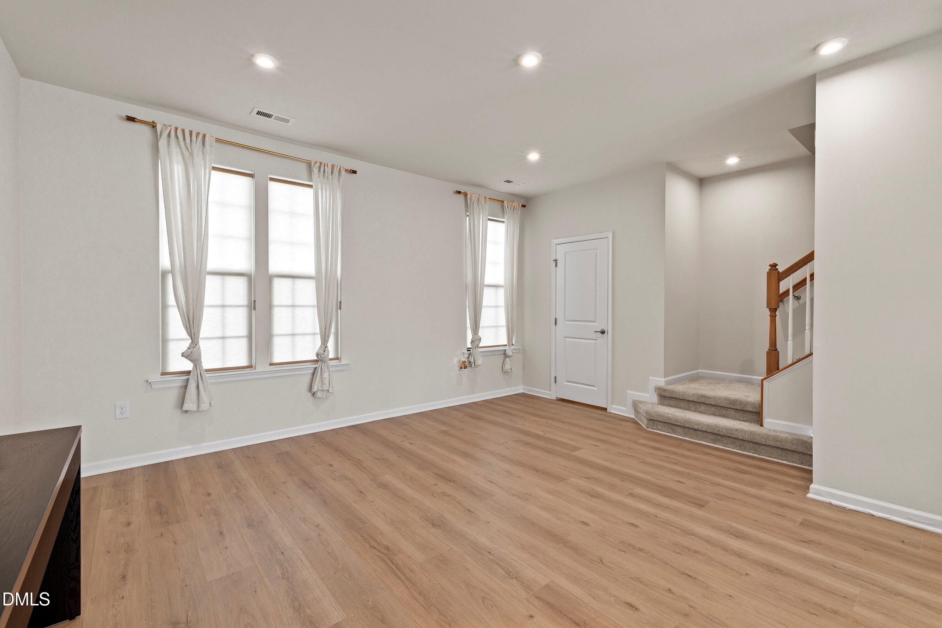 6430 Pathfinder Way Raleigh, NC 27616 - Photo 14 of 39 an empty room with wooden floor and windows