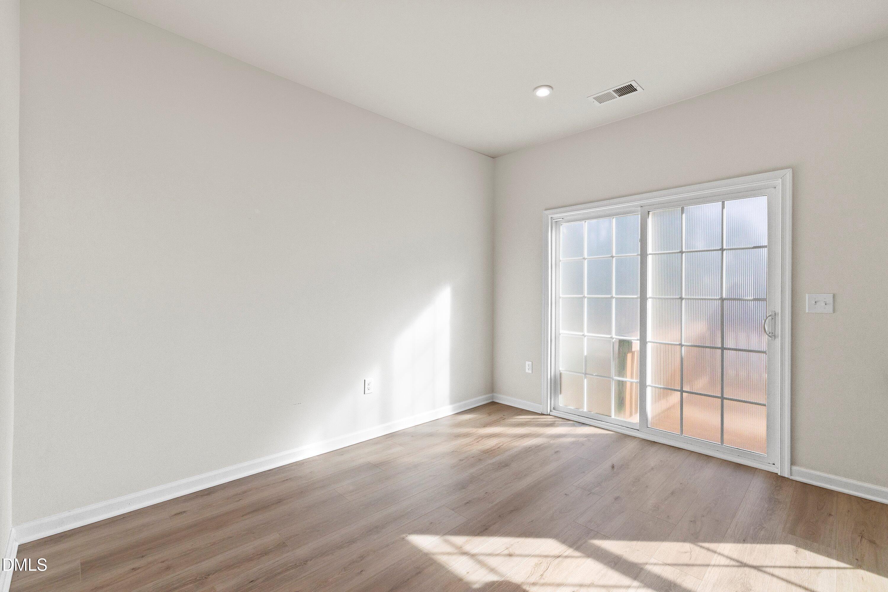6430 Pathfinder Way Raleigh, NC 27616 - Photo 15 of 39 an empty room with wooden floor and windows