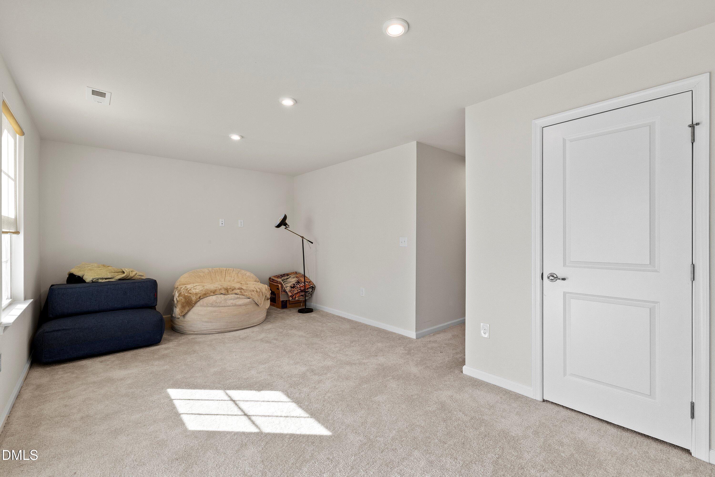 6430 Pathfinder Way Raleigh, NC 27616 - Photo 18 of 39 a room with a closet and couch