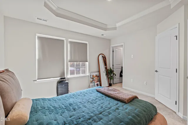 a bedroom with a bed and a dresser with mirror