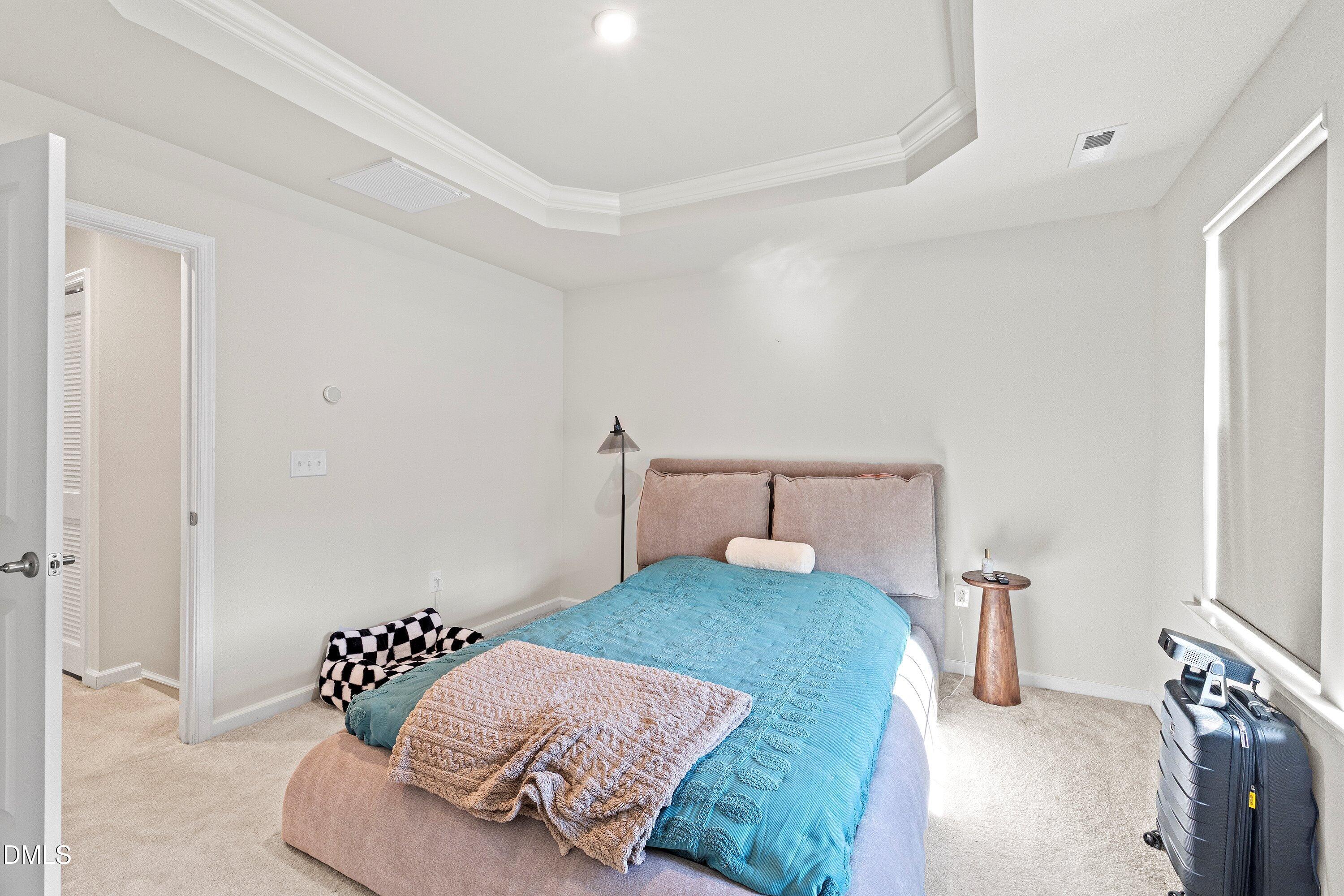 6430 Pathfinder Way Raleigh, NC 27616 - Photo 25 of 39 a bedroom with a bed and wooden floor