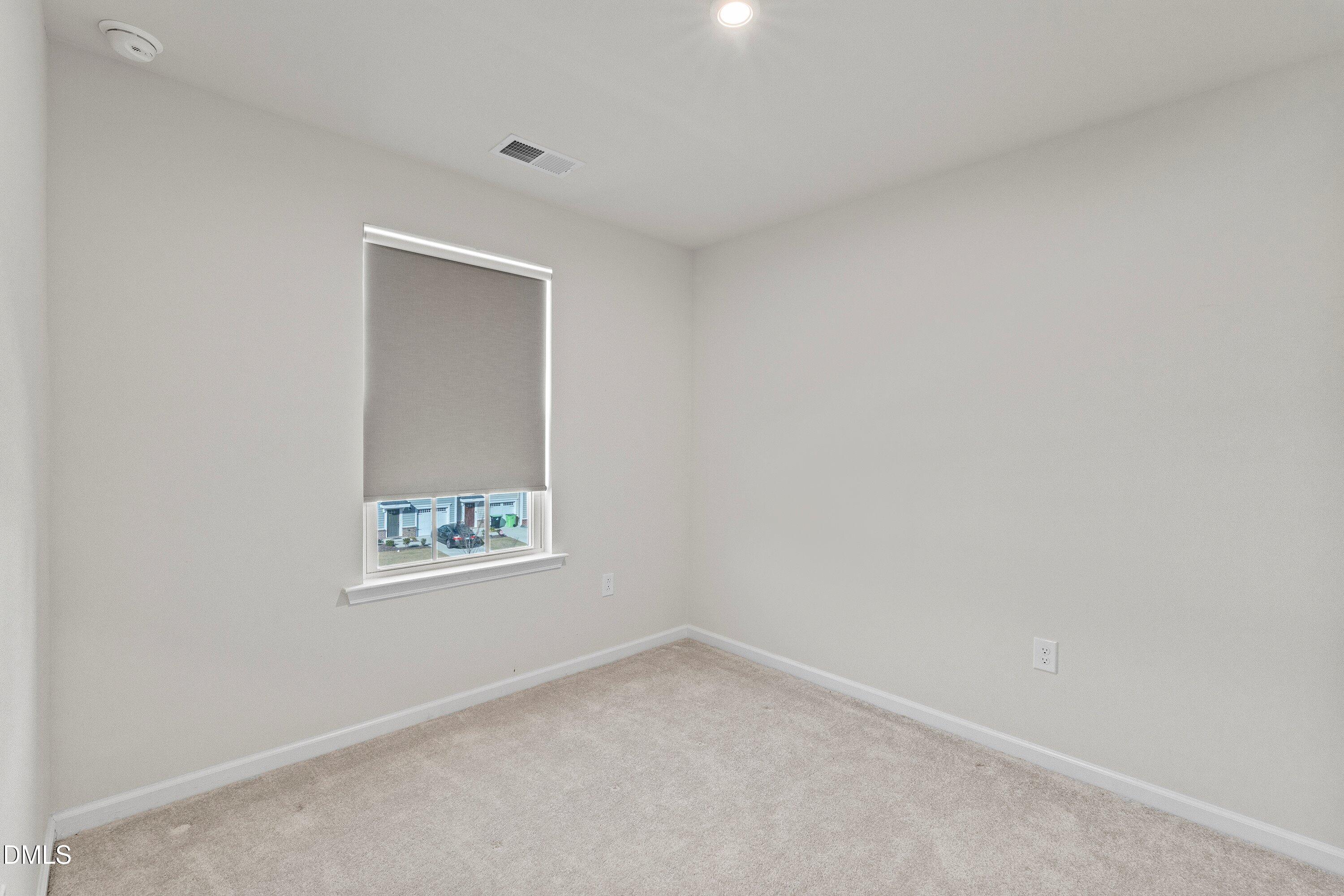 6430 Pathfinder Way Raleigh, NC 27616 - Photo 30 of 39 an empty room with a window