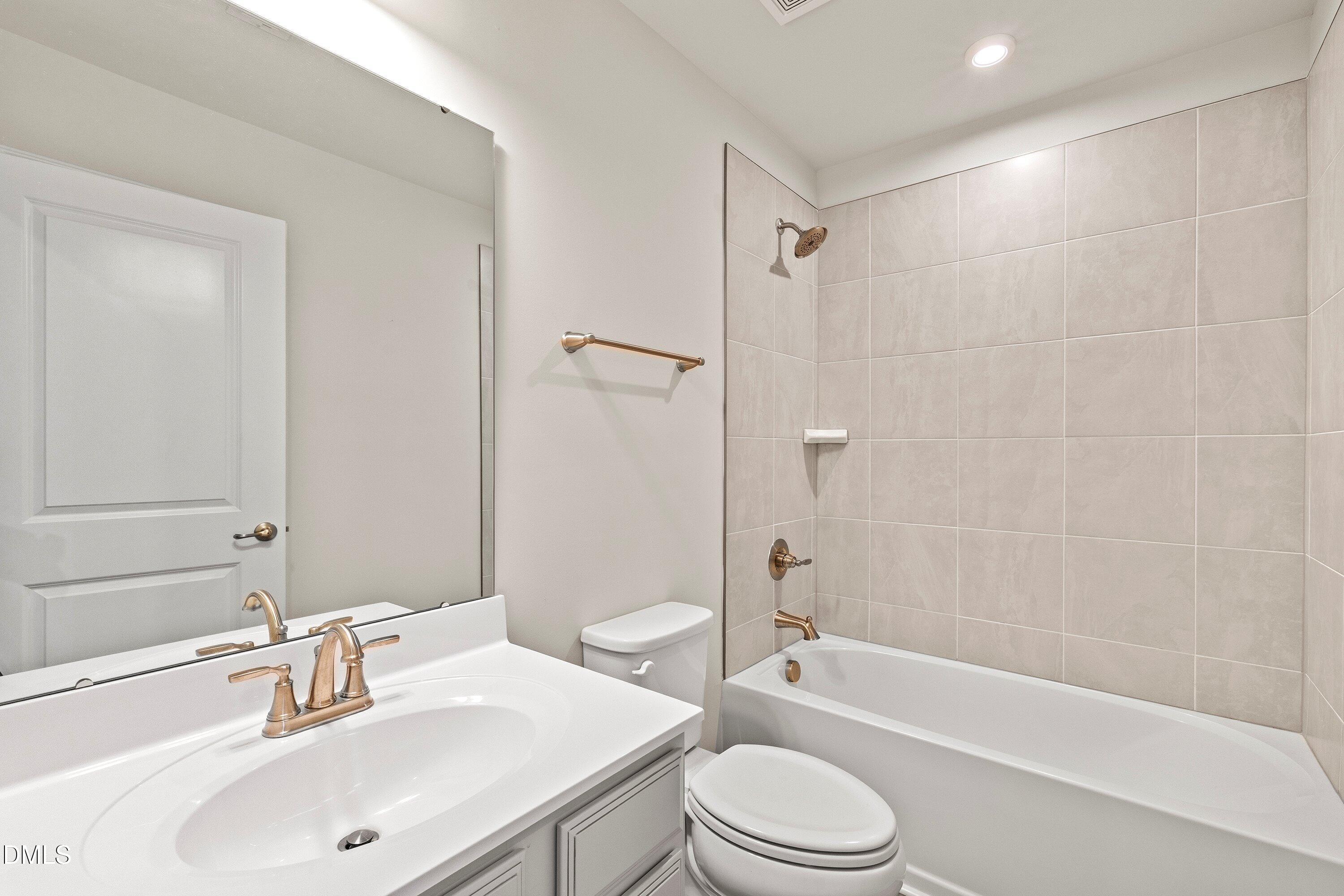 6430 Pathfinder Way Raleigh, NC 27616 - Photo 32 of 39 a bathroom with a sink a toilet and a bathtub