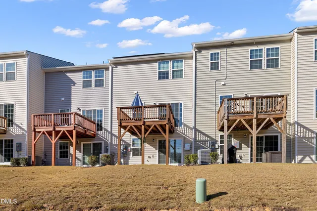a view of a house with wooden deck
