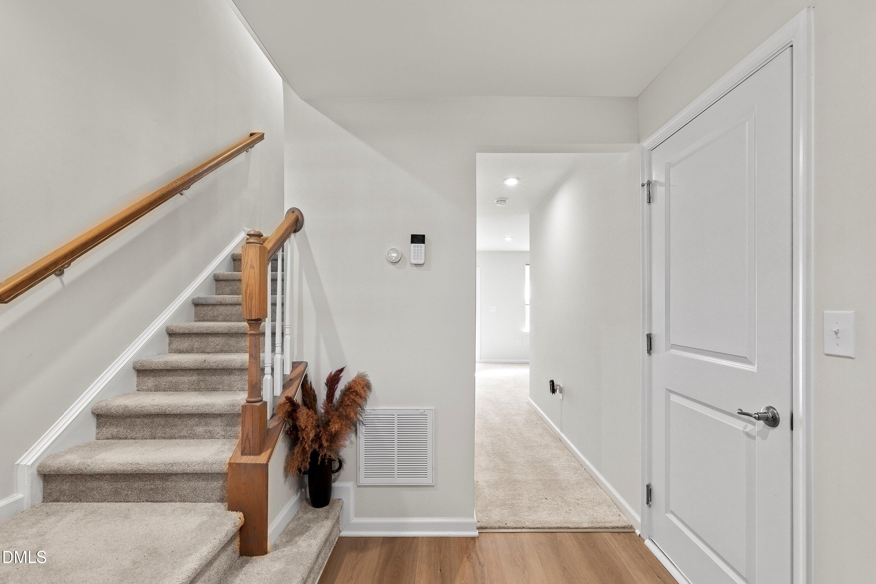 6430 Pathfinder Way Raleigh, NC 27616 - Photo 3 of 39 a view of entryway with wooden floor and stairs