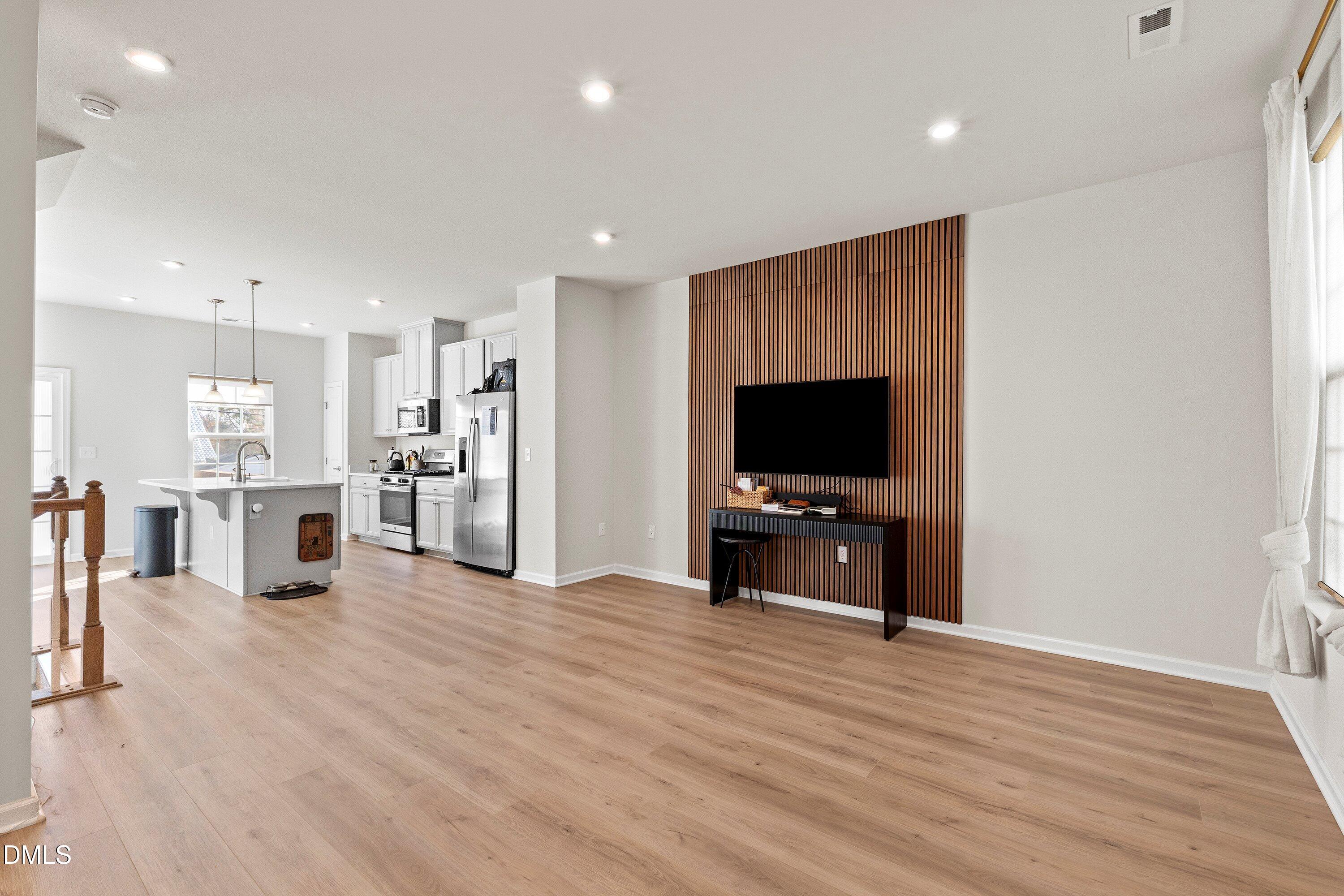 6430 Pathfinder Way Raleigh, NC 27616 - Photo 4 of 39 a view of a kitchen and dining room with wooden floor