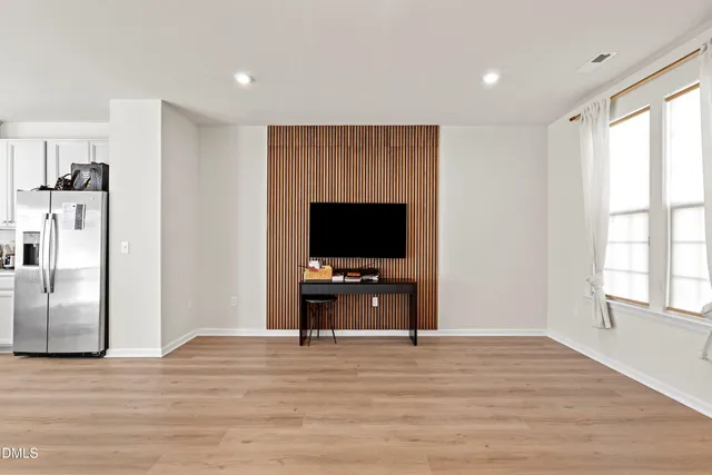 a view of a kitchen and dining room with wooden floor