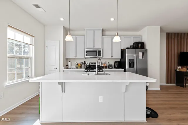 a view of a room with wooden floor and flat screen tv