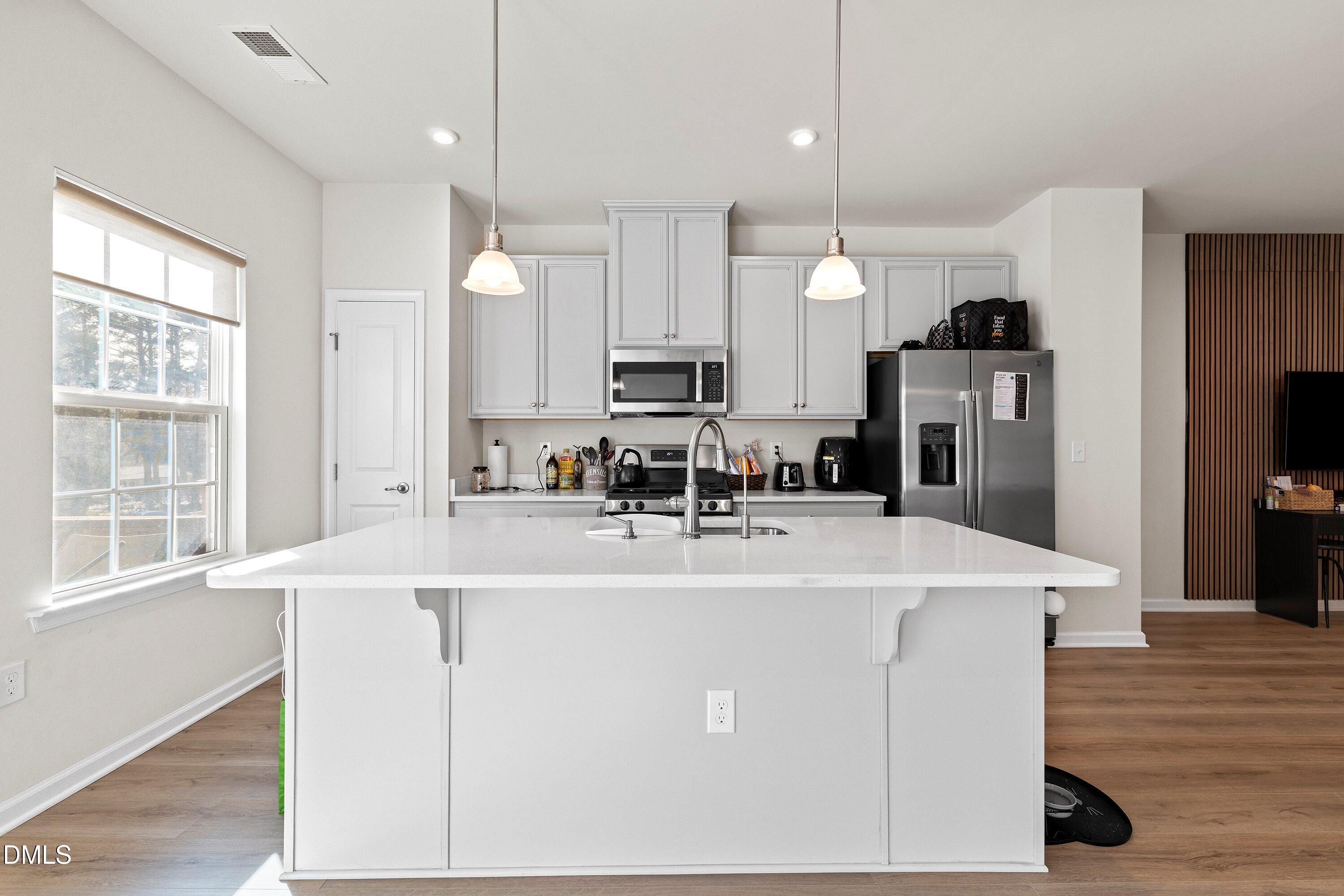 6430 Pathfinder Way Raleigh, NC 27616 - Photo 7 of 39 a view of kitchen with stainless steel appliances granite countertop refrigerator sink and microwave
