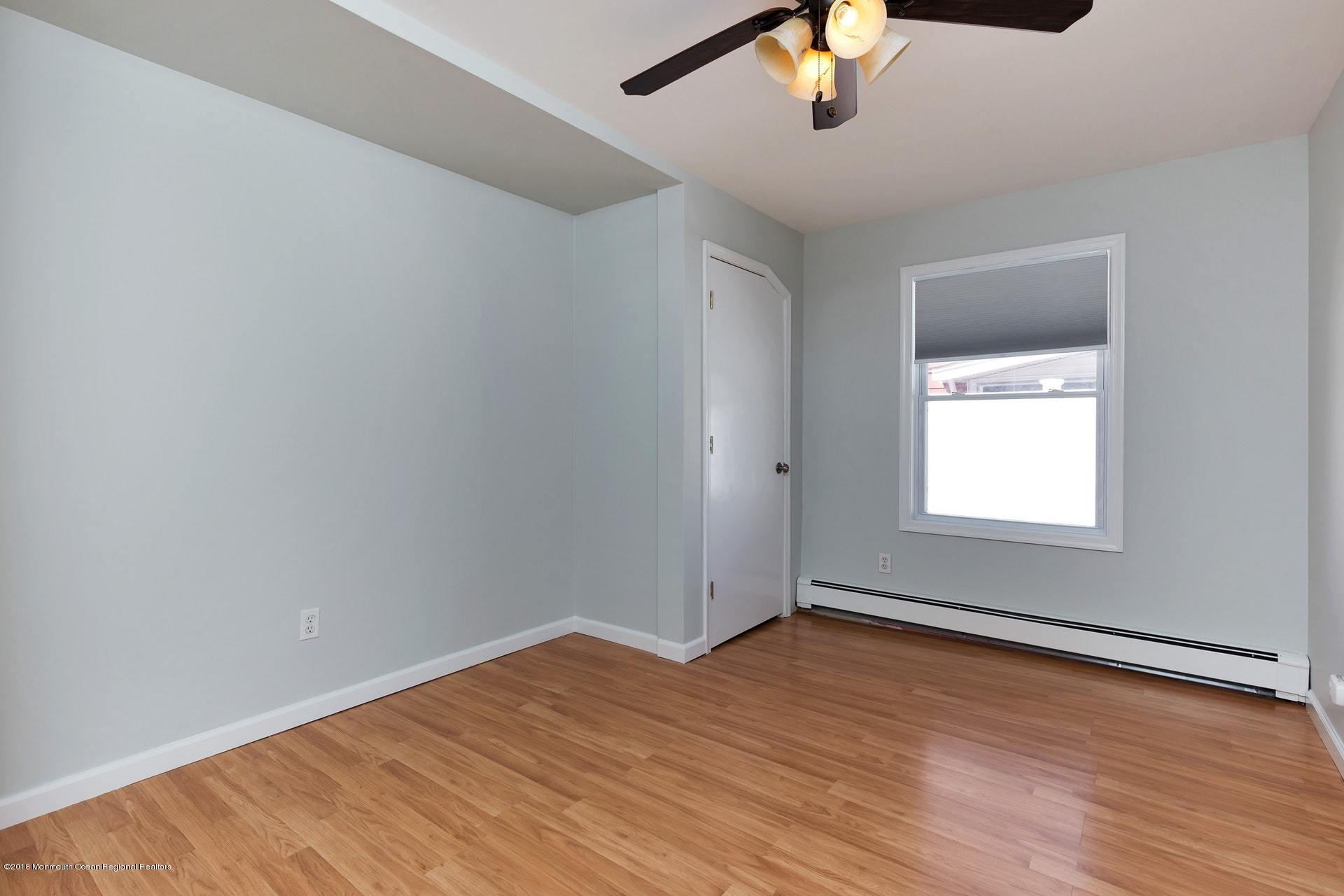 113 Pinehurst Road Brick, NJ 08723 - Photo 14 of 27 wooden floor in an empty room with a window
