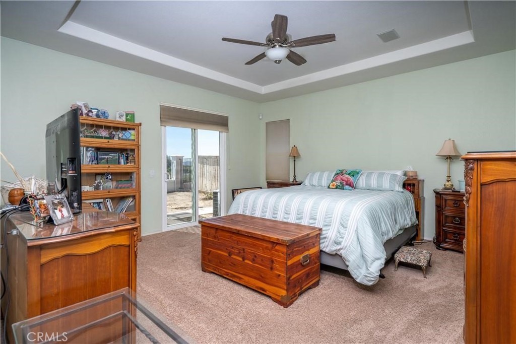 28433 Oasis View Circle Menifee, CA 92584 - Photo 11 of 26 a spacious bedroom with a bed a dresser and a book shelf