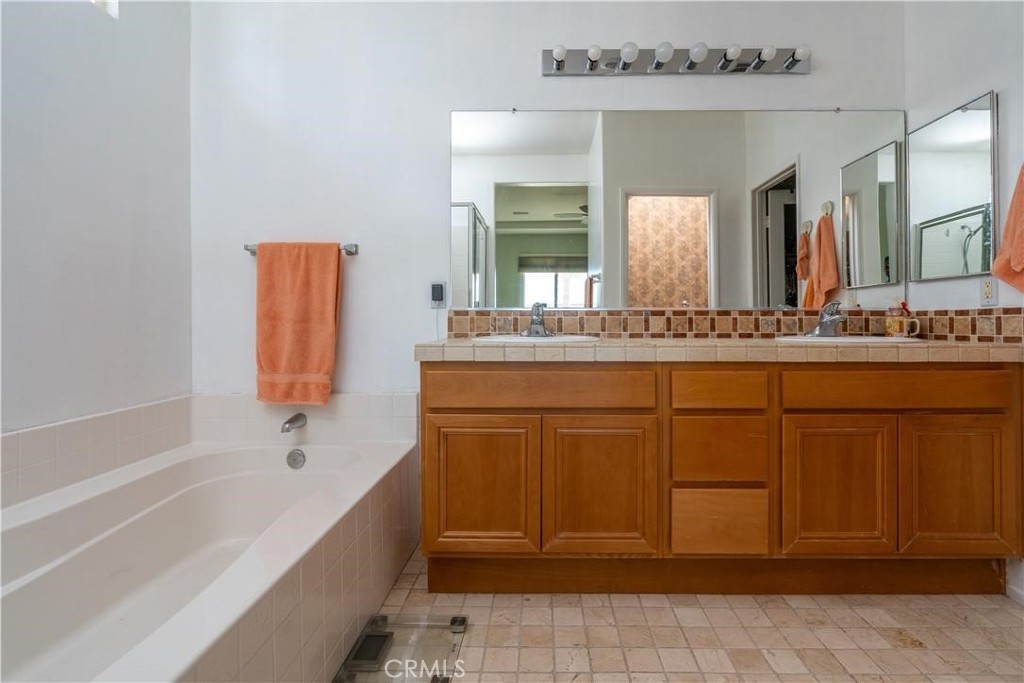28433 Oasis View Circle Menifee, CA 92584 - Photo 14 of 26 a bathroom with a sink and a bathtub