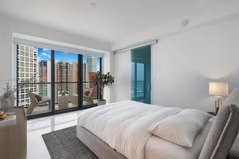 a spacious bedroom with a large bed and a large window