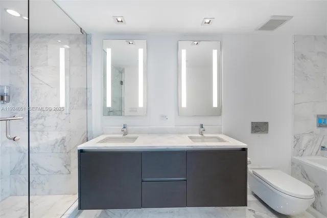a bathroom with double sink and a mirror