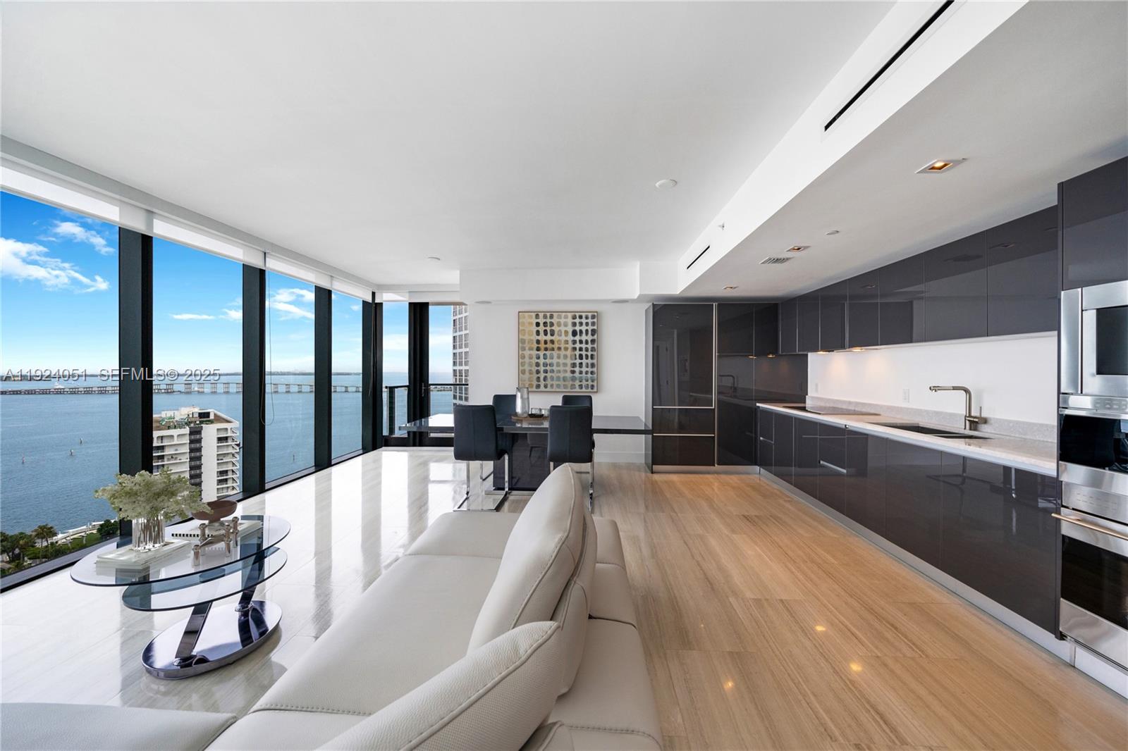 1451 Brickell Avenue, Unit 2003 Miami, FL 33131 - Photo 2 of 36 a large white kitchen with a large window and stainless steel appliances