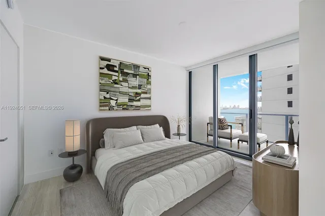 a bedroom with a bed a couch and large window