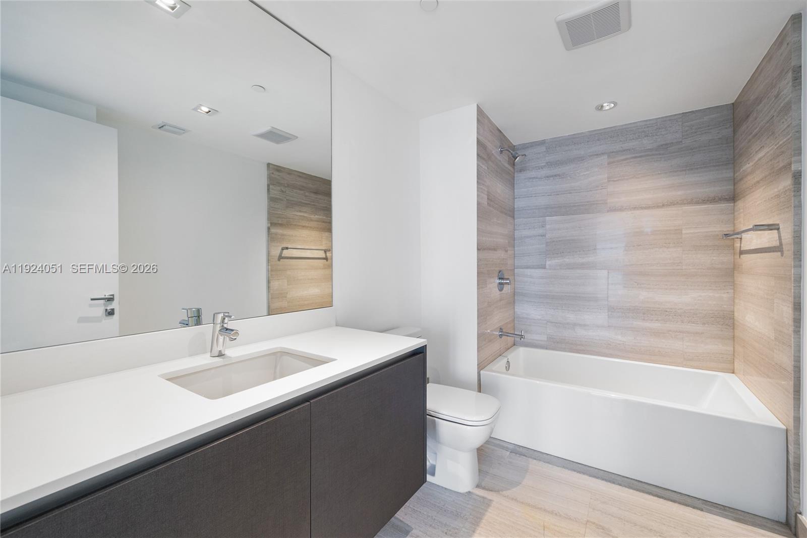1451 Brickell Avenue, Unit 2003 Miami, FL 33131 - Photo 25 of 36 a bathroom with a sink mirror toilet and bathtub