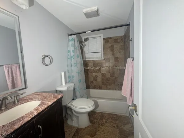 a bedroom with a bed and painting on the wall