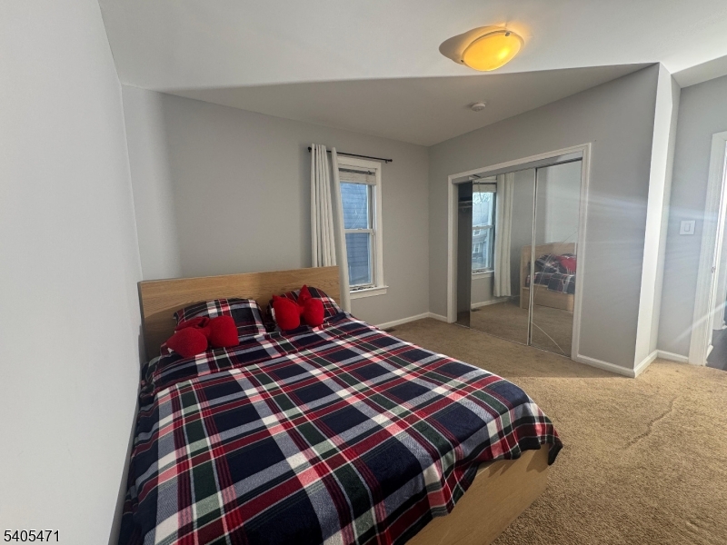 835 Dixie Lane Plainfield, NJ 07062 - Photo 16 of 37 a bedroom with a bed and painting on the wall