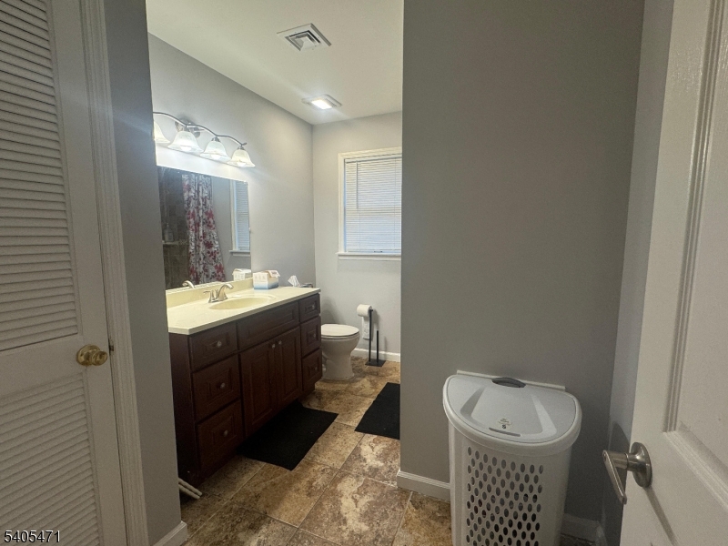 835 Dixie Lane Plainfield, NJ 07062 - Photo 19 of 37 a bathroom with a sink and a mirror