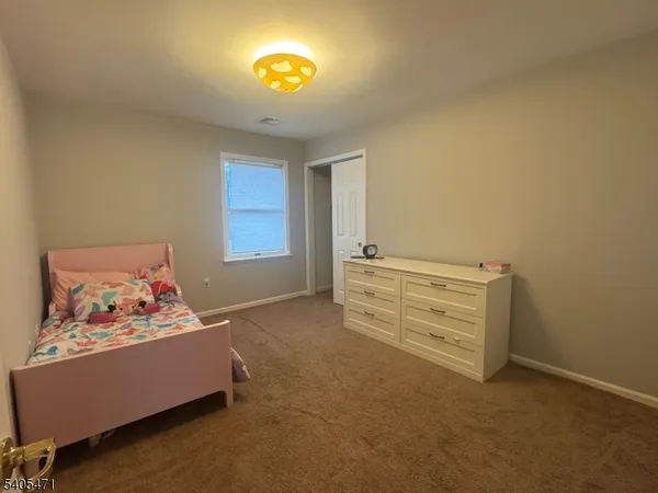 a bedroom with bed and a window