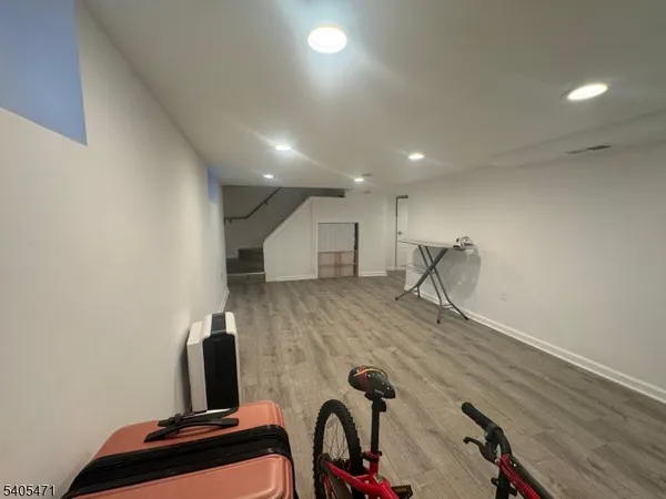 a view of a room with wooden floor and a table
