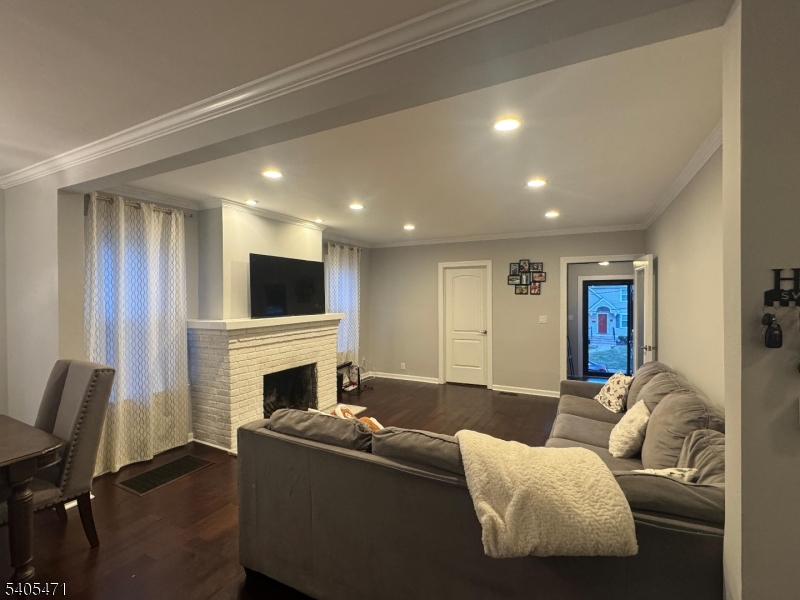 835 Dixie Lane Plainfield, NJ 07062 - Photo 36 of 37 a living room with furniture a flat screen tv and a fireplace
